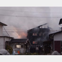 墜落で炎上し煙を上げる住宅（Ｃ）共同通信社