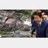 火災の鎮火から一夜が明けた首里城（左）と安倍首相（Ｃ）共同通信社