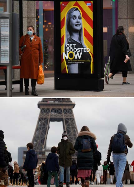 英仏では1日新規感染者が10万人にも…（上から、英ロンドン街中にはブースター接種推奨の看板が。仏パリ16区、エッフェル塔傍のトロカデロ広場をマスク姿で歩く人たち）／（Ｃ）ロイター