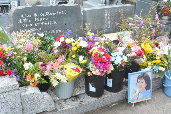 墓の横に設置された記念碑にも多くの花が手向けられていた（提供写真）