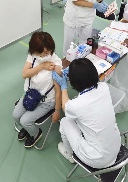 大規模接種会場でワクチン接種を受ける女性（代表撮影）